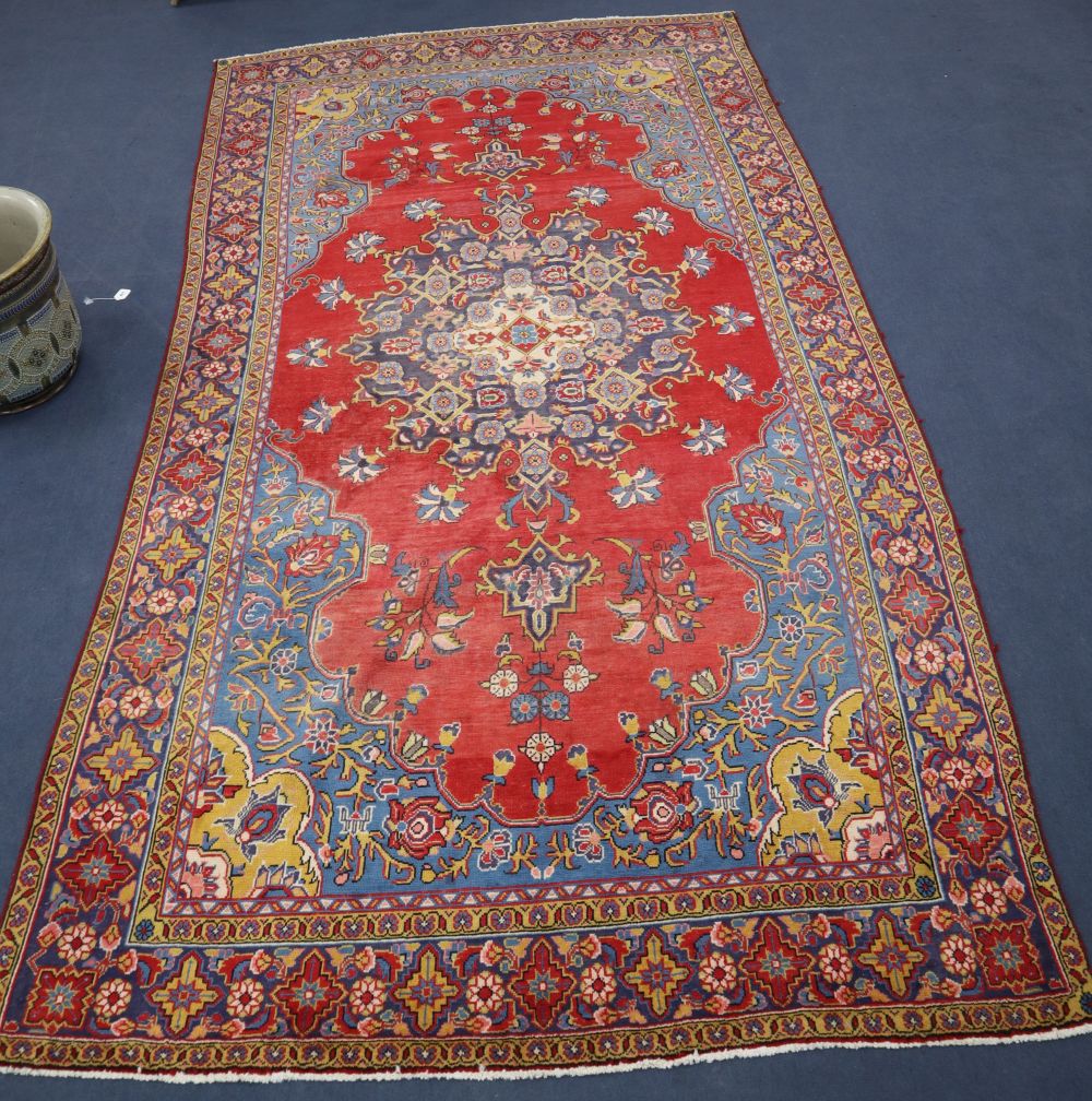 A Tabriz-style red ground carpet, 400 x 205cm
